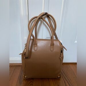 Lionel Crossbody Bag. Top Handle Carry. Sides Expand.